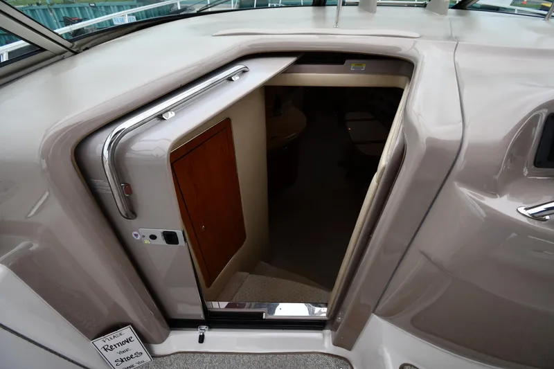 Slide: The Image of Entrance to cabin of 2000 Sea Ray 460 Sundancer yacht, featuring sleek design and wooden door. - 27