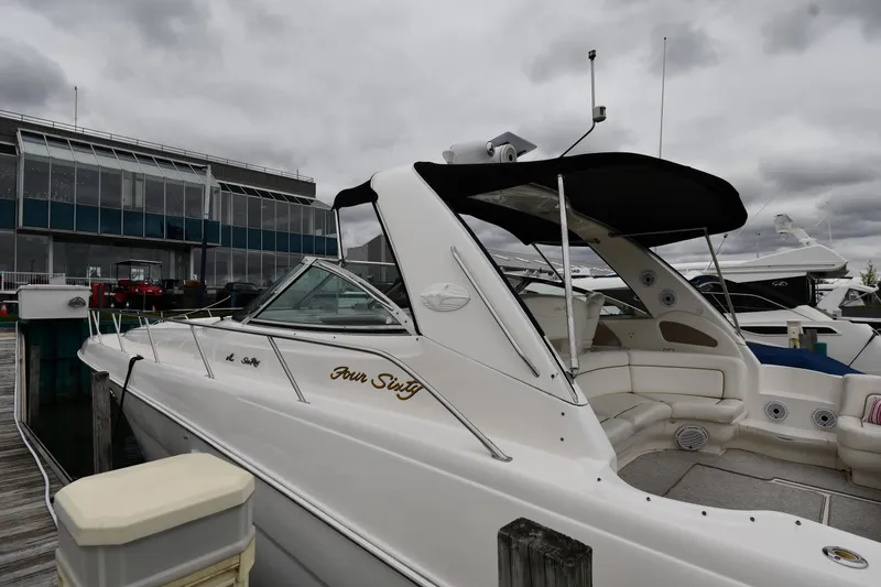 Slide: The Image of 2000 Sea Ray 460 Sundancer yacht docked at marina under cloudy skies. - 3
