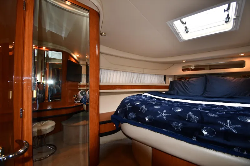 Slide: The Image of Luxurious cabin interior of 2000 Sea Ray 460 Sundancer yacht with plush bedding. - 31