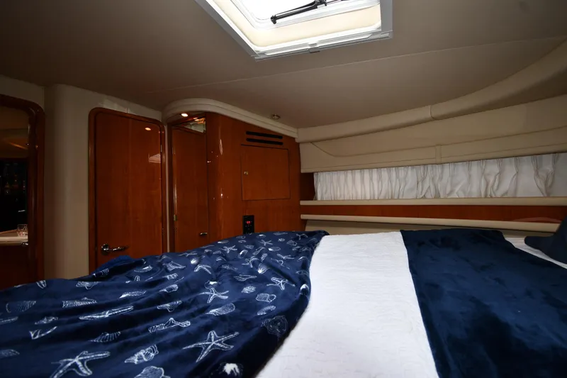 Slide: The Image of Luxurious cabin interior of 2000 Sea Ray 460 Sundancer yacht with skylight and nautical bedding. - 32