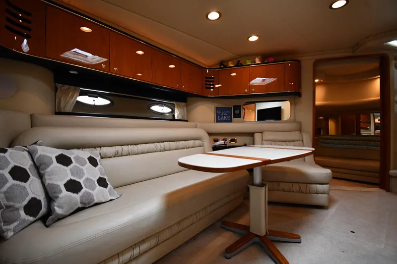 Slide: The Image of Luxurious interior of 2000 Sea Ray 460 Sundancer yacht with elegant seating and wooden cabinetry. - 40
