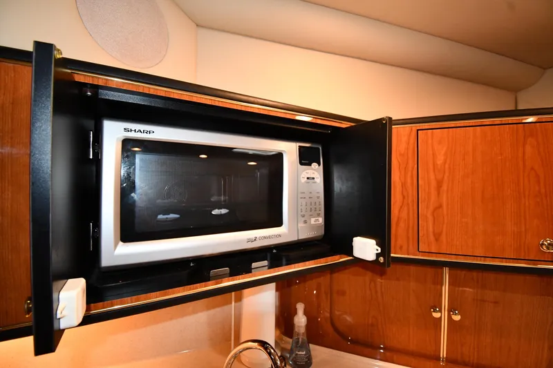 Slide: The Image of Microwave in 2000 Sea Ray 460 Sundancer yacht kitchen, wooden cabinetry. - 44