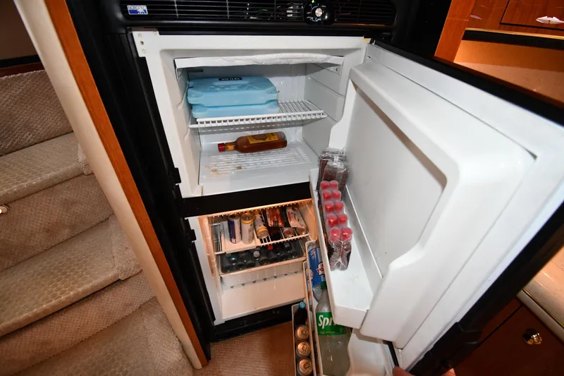 Slide: The Image of Open refrigerator on 2000 Sea Ray 460 Sundancer yacht, stocked with drinks and ice packs. - 46