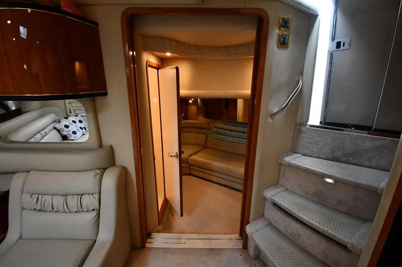 Slide: The Image of Interior of 2000 Sea Ray 460 Sundancer yacht, featuring luxurious seating and carpeted stairs. - 47