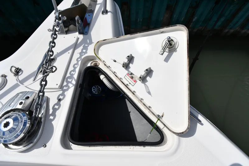 Slide: The Image of Open anchor hatch on 2000 Sea Ray 460 Sundancer boat, showing chain and winch. - 5