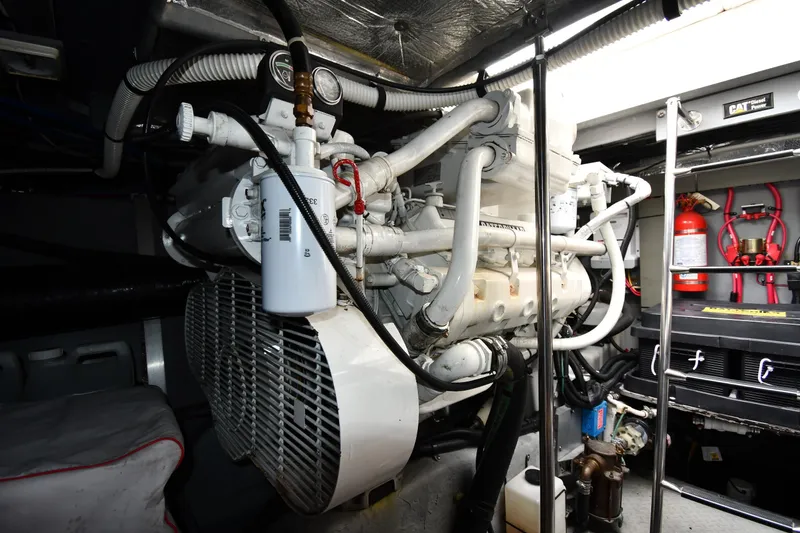 Slide: The Image of Engine room of 2000 Sea Ray 460 Sundancer with visible machinery and fire extinguisher. - 58
