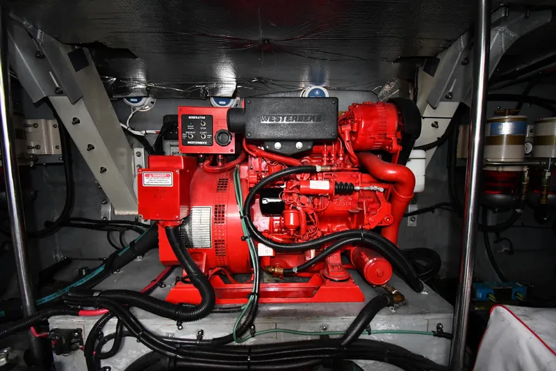 Slide: The Image of Engine room of 2000 Sea Ray 460 Sundancer with red Westerbeke generator. - 61