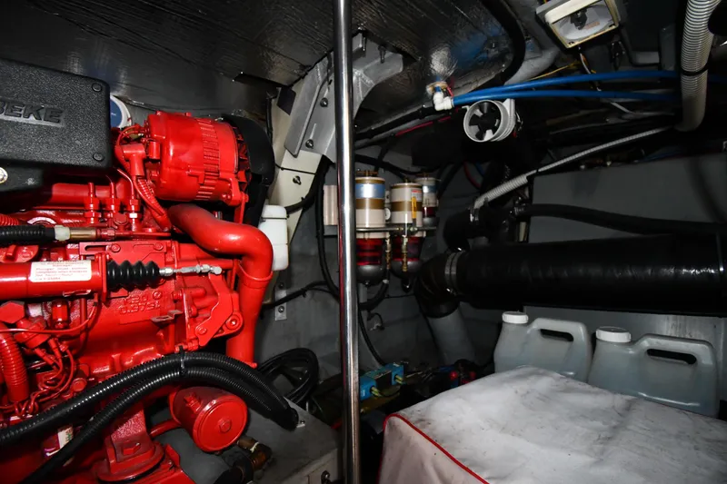 Slide: The Image of Engine room of 2000 Sea Ray 460 Sundancer with red engine components and fuel filters. - 62