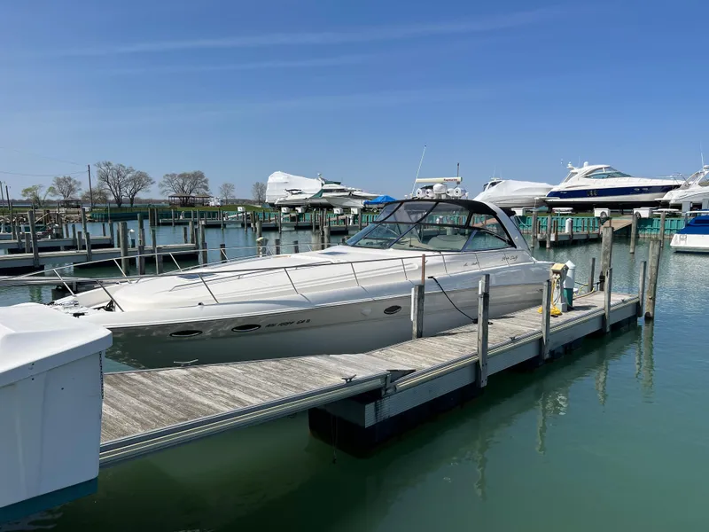 Slide: The Image of 2000 Sea Ray 460 Sundancer docked at marina under clear blue sky. - 66
