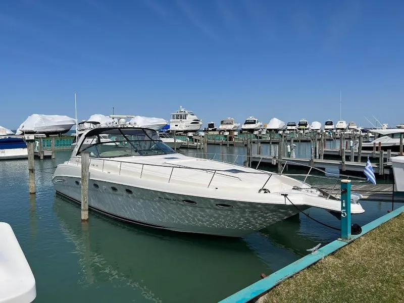 Slide: The Image of 2000 Sea Ray 460 Sundancer yacht docked in a marina under clear blue skies. - 69