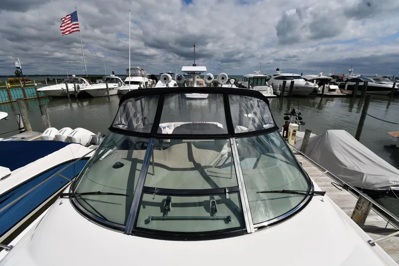 Slide: The Image of 2000 Sea Ray 460 Sundancer yacht docked at marina under cloudy sky. - 7