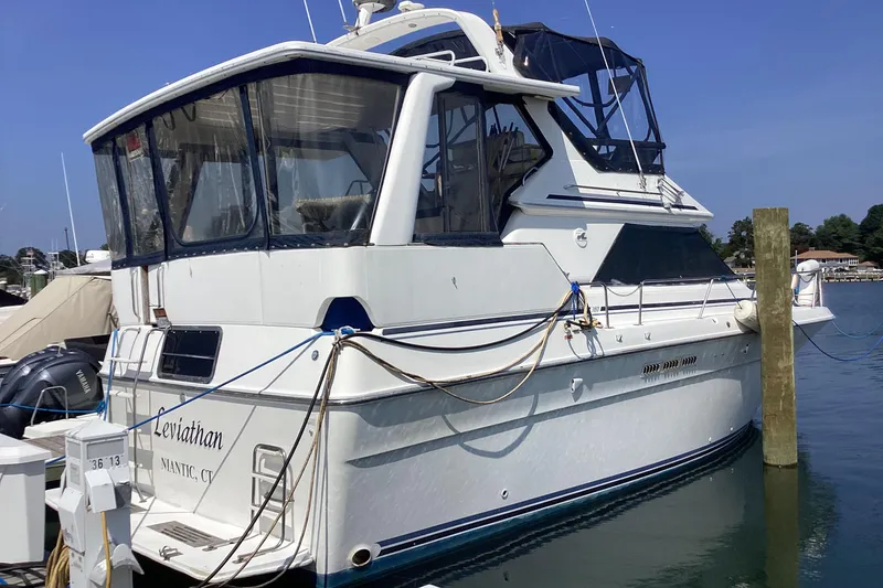 The Image of 1989 Sea Ray 380 Aft Cabin yacht docked at marina, side view. - 1