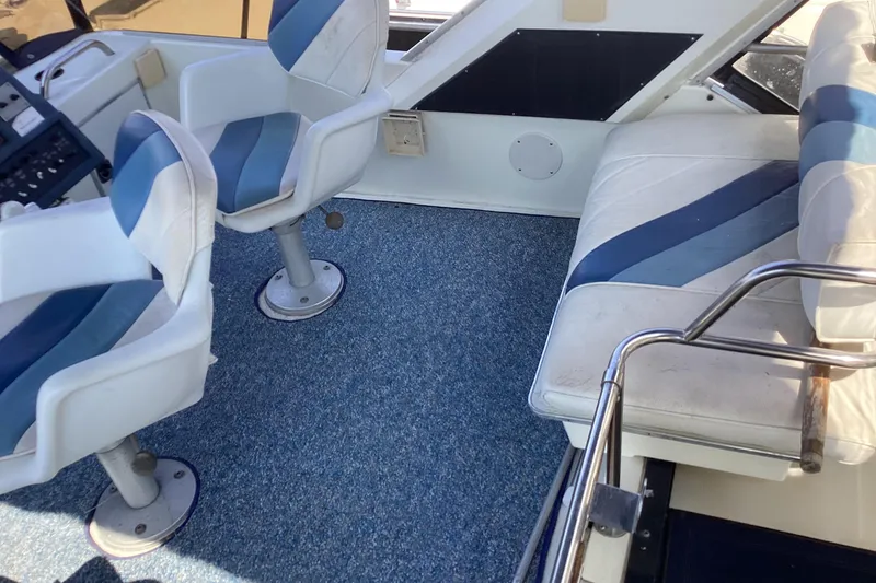 Slide: The Image of 1989 Sea Ray 380 Aft Cabin interior with blue and white seating and carpet. - 10