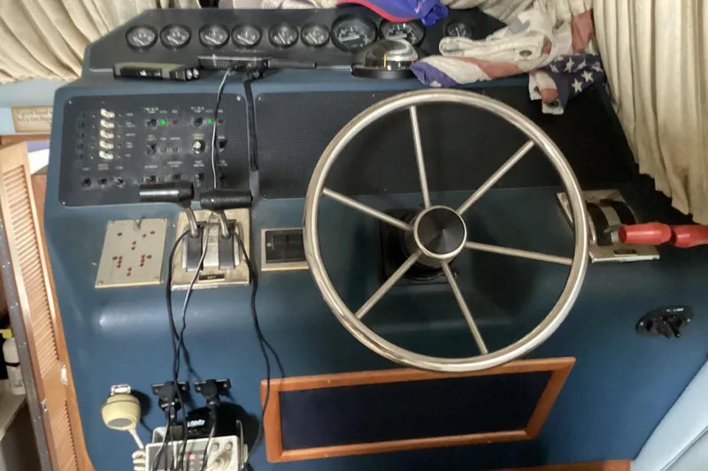Slide: The Image of 1989 Sea Ray 380 Aft Cabin helm with steering wheel and control panel. - 11