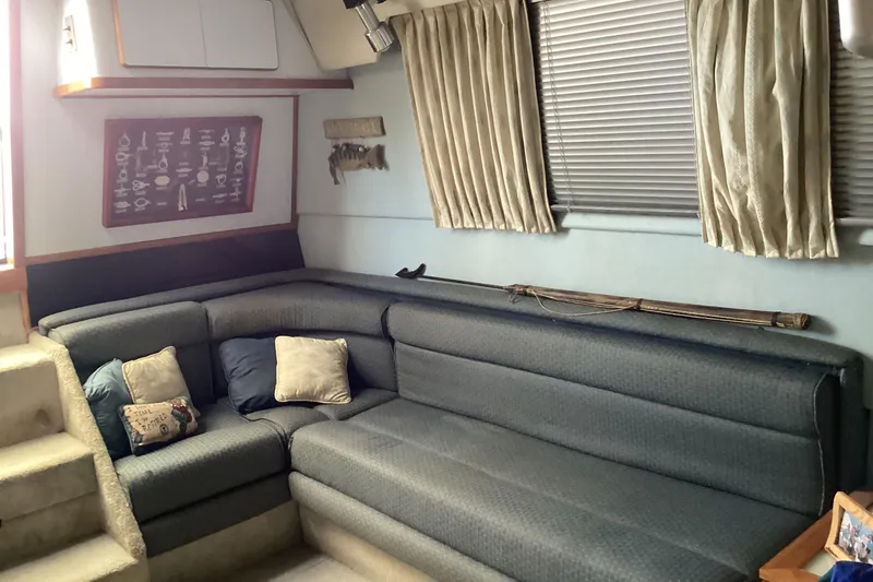 Slide: The Image of Interior of 1989 Sea Ray 380 Aft Cabin with cozy seating and nautical decor. - 12