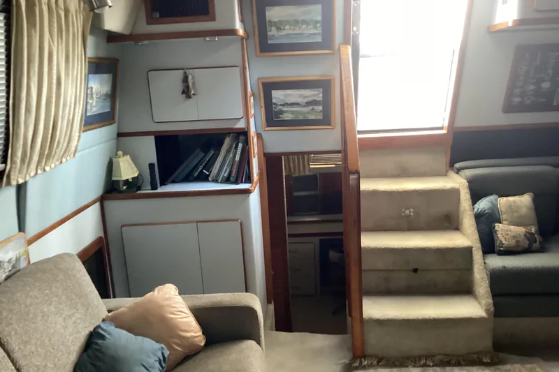 Slide: The Image of Interior of 1989 Sea Ray 380 Aft Cabin with cozy seating and decorative elements. - 13