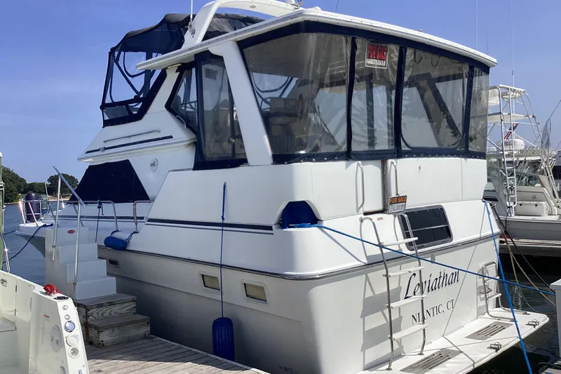 Slide: The Image of 1989 Sea Ray 380 Aft Cabin yacht docked, featuring "For Sale" sign. - 2