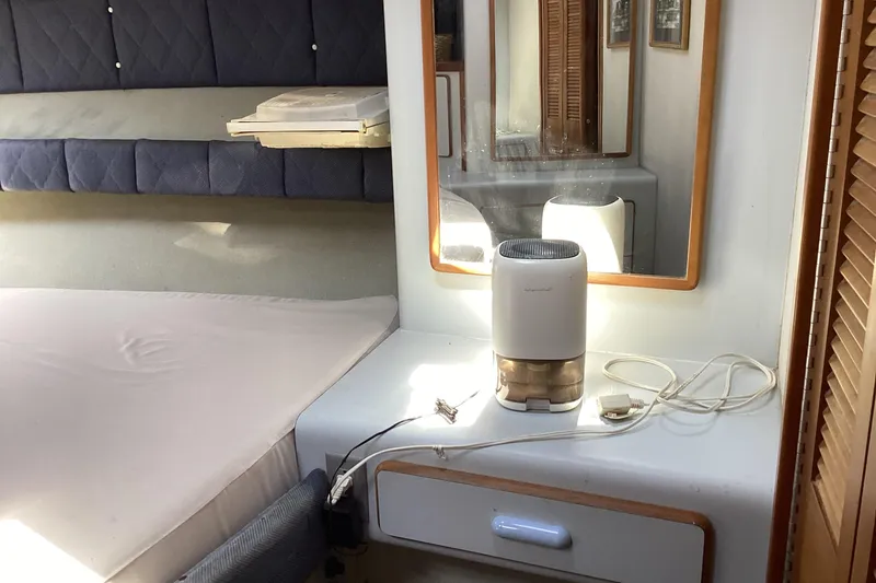 Slide: The Image of Interior of 1989 Sea Ray 380 Aft Cabin with mirror and dehumidifier on dresser. - 20