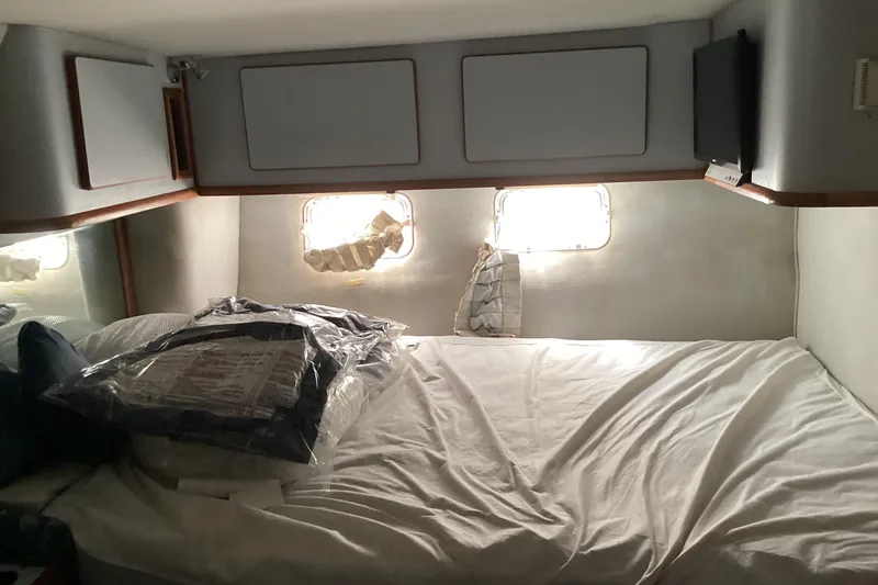 Slide: The Image of Cozy cabin interior of 1989 Sea Ray 380 Aft Cabin yacht with bed and windows. - 22