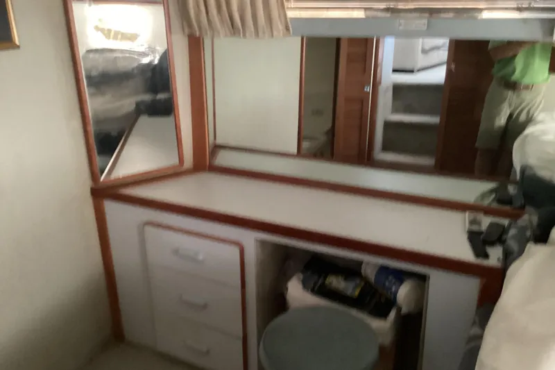 Slide: The Image of 1989 Sea Ray 380 Aft Cabin interior with vanity and mirror setup. - 23