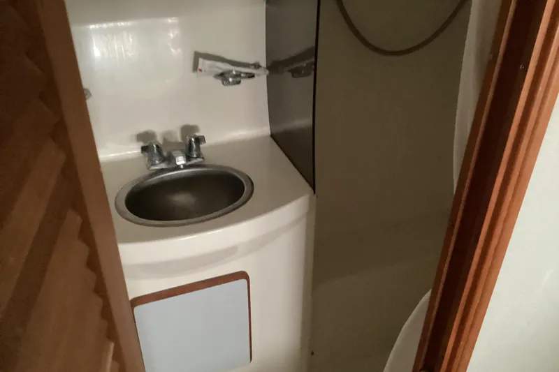 Slide: The Image of 1989 Sea Ray 380 Aft Cabin bathroom with sink and faucet. - 25