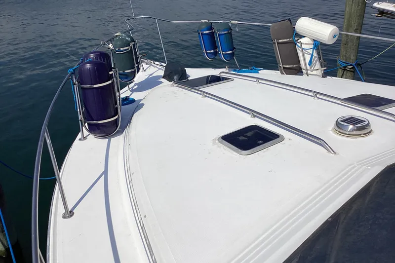 Slide: The Image of 1989 Sea Ray 380 Aft Cabin boat deck with fenders and railing. - 4