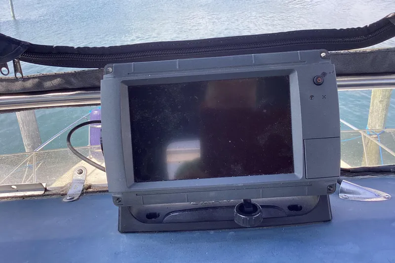 Slide: The Image of 1989 Sea Ray 380 Aft Cabin boat dashboard with navigation display, overlooking water. - 8