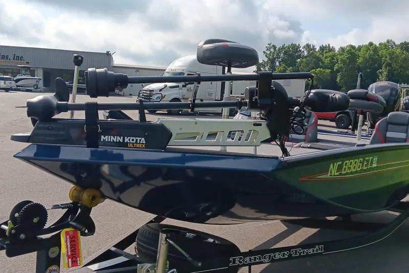 Slide: The Image of 2021 Ranger RT188P boat with Minn Kota Ultrex motor in a parking lot. - 6