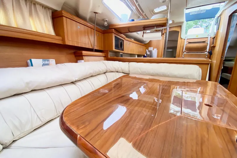 Slide: The Image of Luxurious interior of 2003 Hunter 386 sailboat with polished wood and comfortable seating. - 11