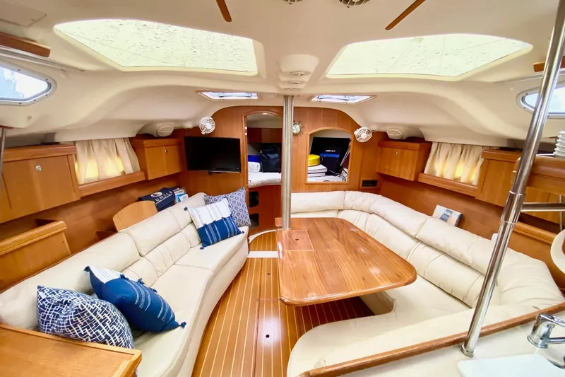 Slide: The Image of Luxurious interior of a 2003 Hunter 386 sailboat with plush seating and wooden finishes. - 14