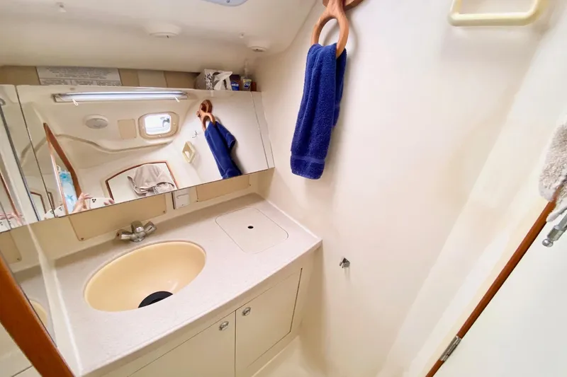 Slide: The Image of Bathroom interior of a 2003 Hunter 386 yacht, featuring a sink and mirror. - 17