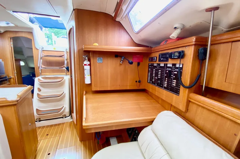 Slide: The Image of Interior of 2003 Hunter 386 sailboat with navigation station and wooden cabinetry. - 18