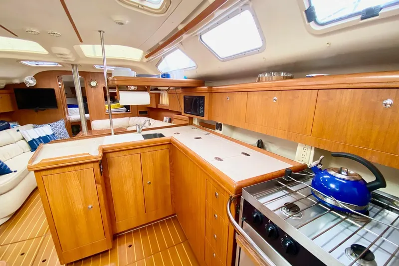 Slide: The Image of Interior of 2003 Hunter 386 yacht with wooden cabinetry and modern kitchen amenities. - 25