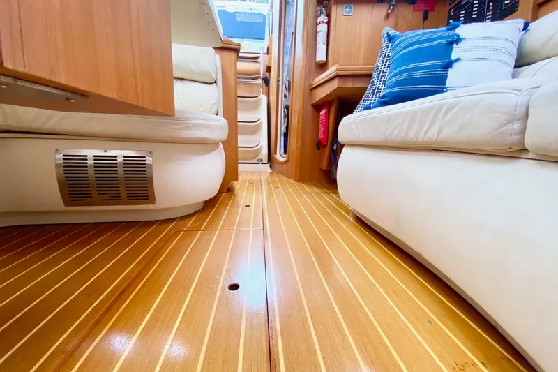 Slide: The Image of Interior of 2003 Hunter 386 yacht with wooden flooring and comfortable seating. - 28