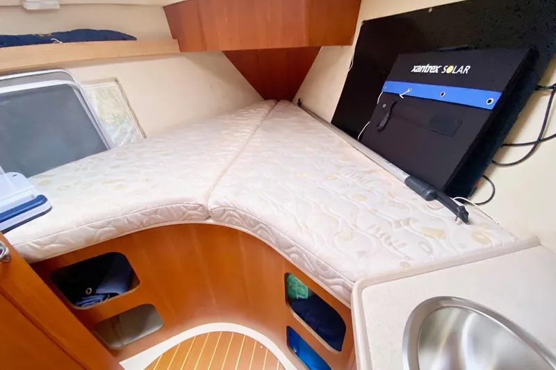 Slide: The Image of Cozy cabin interior of 2003 Hunter 386 sailboat with mattress and solar panel. - 30