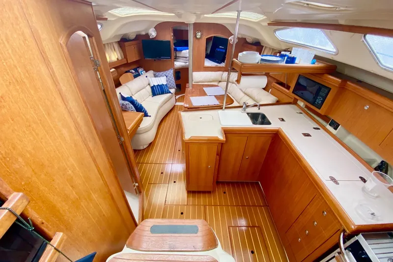 Slide: The Image of Luxurious interior of 2003 Hunter 386 sailboat with wood finish and modern amenities. - 4