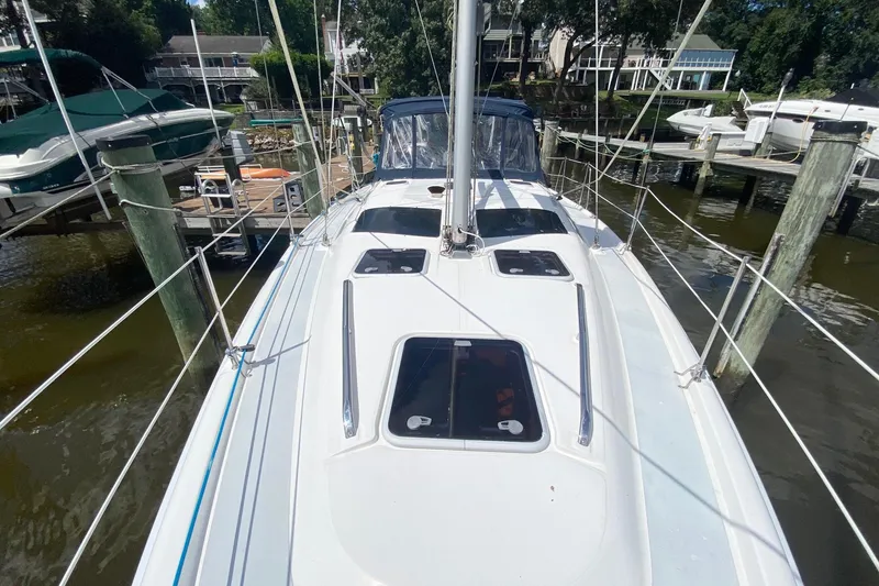 Slide: The Image of 2003 Hunter 386 sailboat docked at a marina, showcasing deck and rigging. - 45