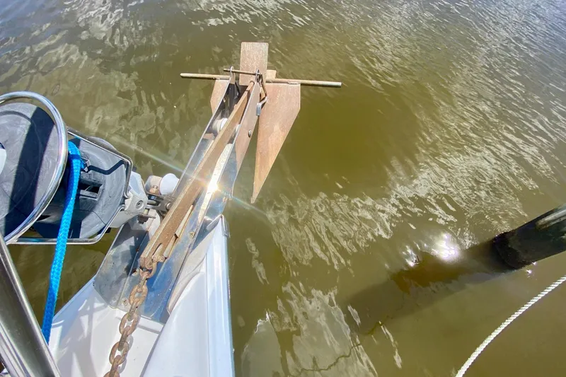 Slide: The Image of Bow of 2003 Hunter 386 sailboat with anchor and blue rope in water. - 46