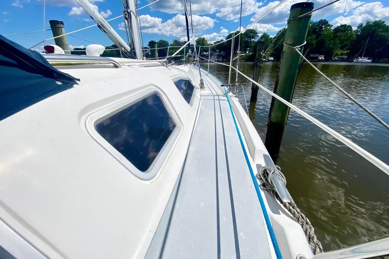 Slide: The Image of 2003 Hunter 386 sailboat docked on a sunny day, showcasing deck and rigging. - 48