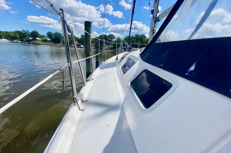 Slide: The Image of 2003 Hunter 386 sailboat deck with clear sky and water view. - 49