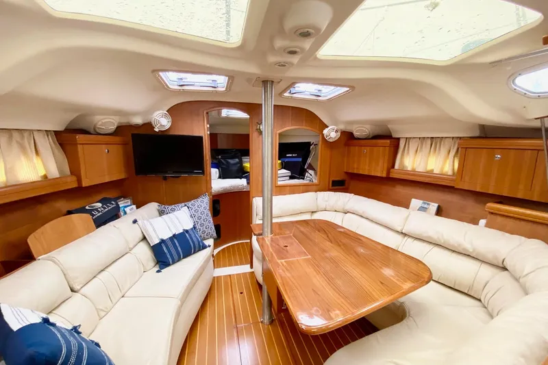 Slide: The Image of Luxurious interior of 2003 Hunter 386 yacht with plush seating and wooden finishes. - 5