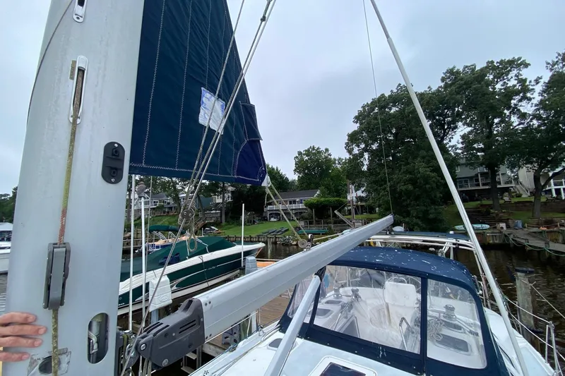 Slide: The Image of Sailboat Hunter 386, 2003 model, docked with raised sail and visible cockpit. - 50