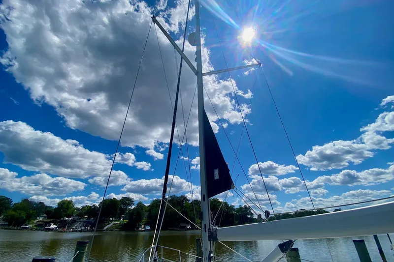 Slide: The Image of Sailboat mast of 2003 Hunter 386 under bright blue sky with clouds. - 52