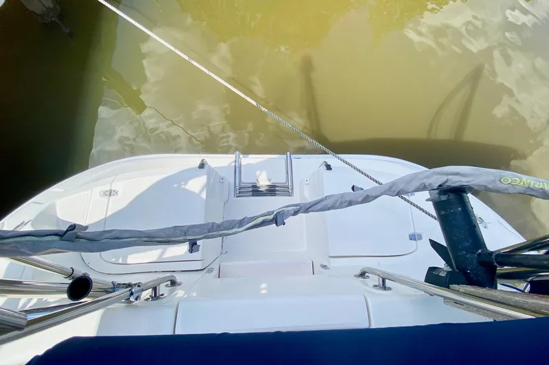 Slide: The Image of Hunter 386 sailboat deck, 2003 model, with railing and water reflection. - 59