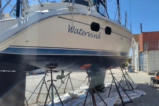 Slide: The Image of 2003 Hunter 386 sailboat "Waterwind" on stands for maintenance in a boatyard. - 67