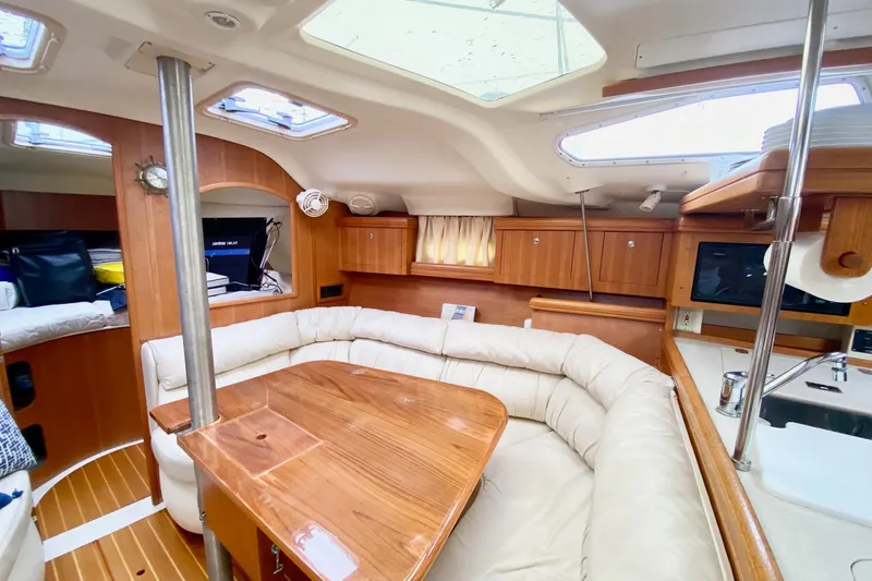 Slide: The Image of Interior of 2003 Hunter 386 sailboat with cozy seating and wooden finishes. - 8