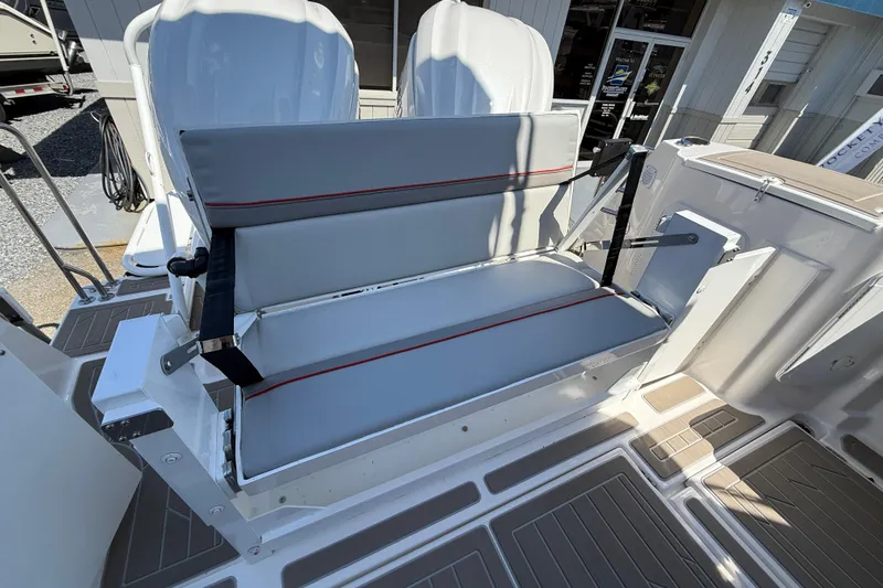 Slide: The Image of 2026 Solara S-310 SB boat seating with gray cushions and red accents. - 11