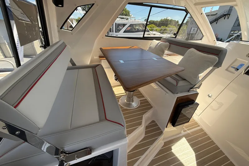 Slide: The Image of Interior of 2026 Solara S-310 SB boat with seating and wooden table. - 15