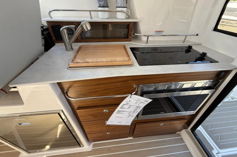 Slide: The Image of Modern kitchen in 2026 Solara S-310 SB boat with stove, sink, and wooden cabinetry. - 17
