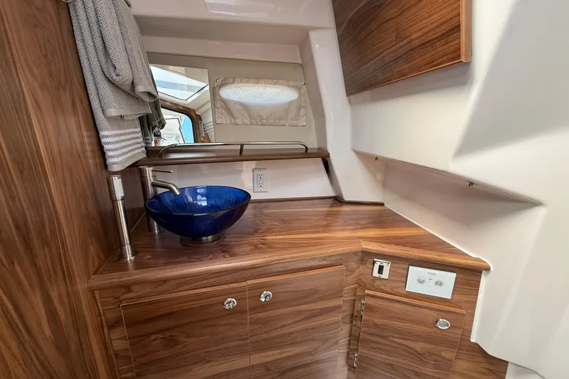 Slide: The Image of Luxurious interior of 2026 Solara S-310 SB with elegant wood finish and modern blue basin. - 21